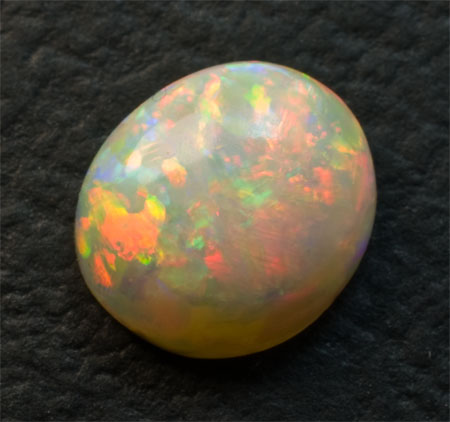 Opale laiteuse très colorée 1.6 carats bombée rouge, jaune, verte et bleu indigo 2990